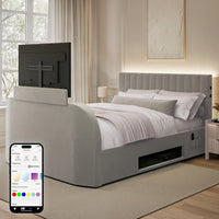 Gray upholstered bed with built-in TV and smartphone displaying app interface in a bedroom.