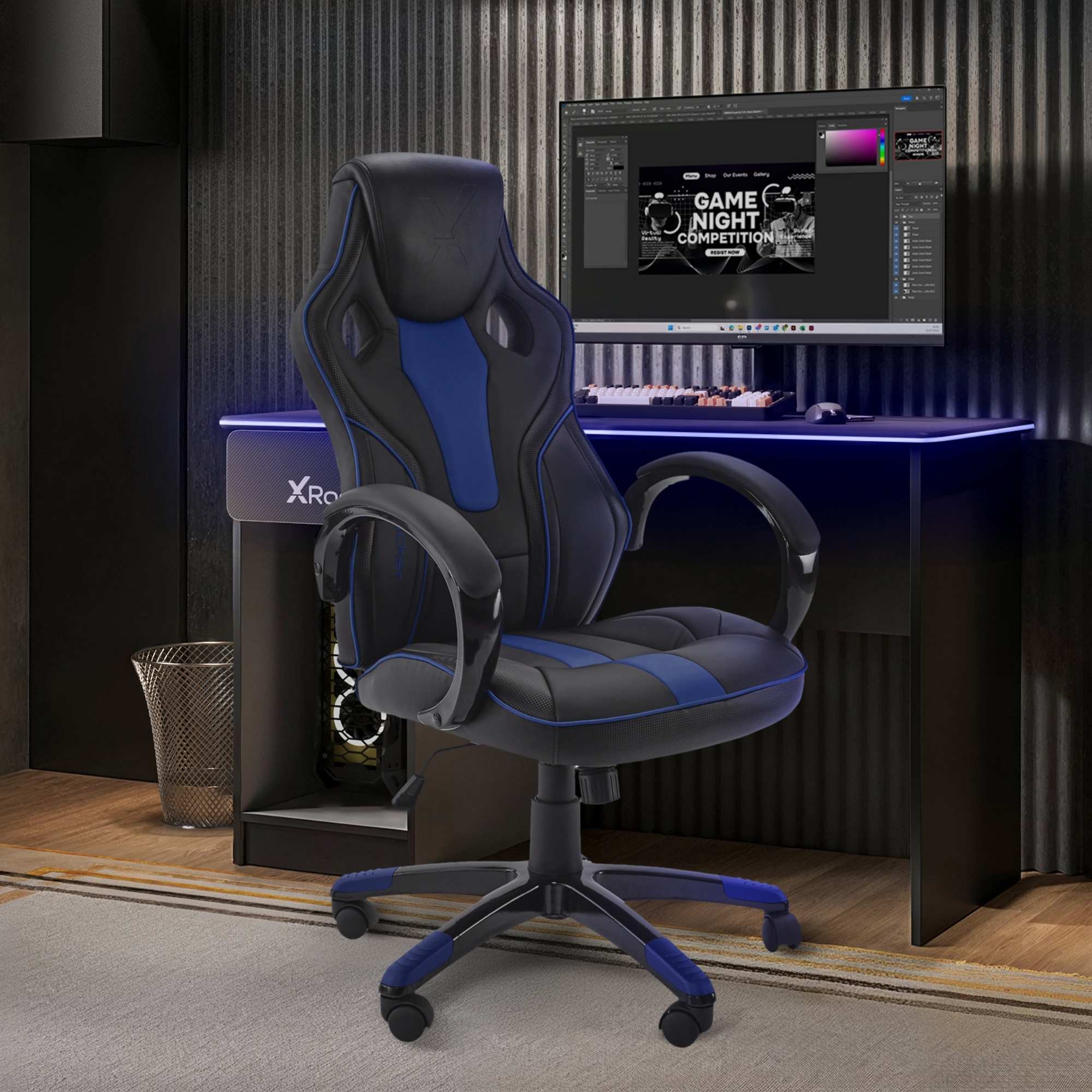 Gaming chair in front of a computer setup on a desk with X Rocker branding.