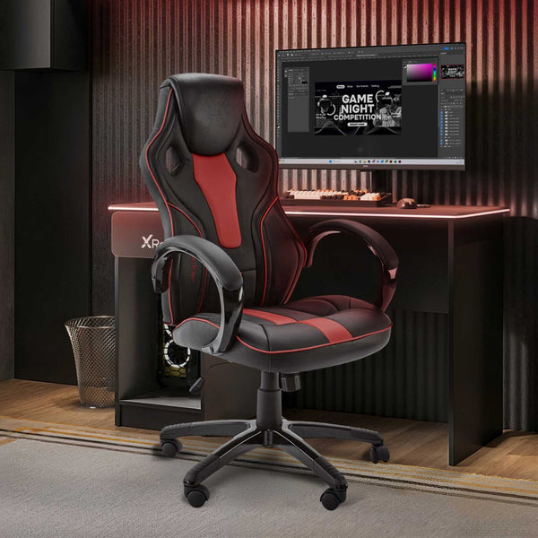 Gaming chair in front of a computer desk with a monitor displaying a game night graphic.