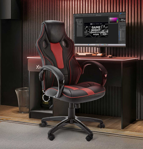 Gaming chair in front of a computer desk with a monitor displaying a game night graphic.