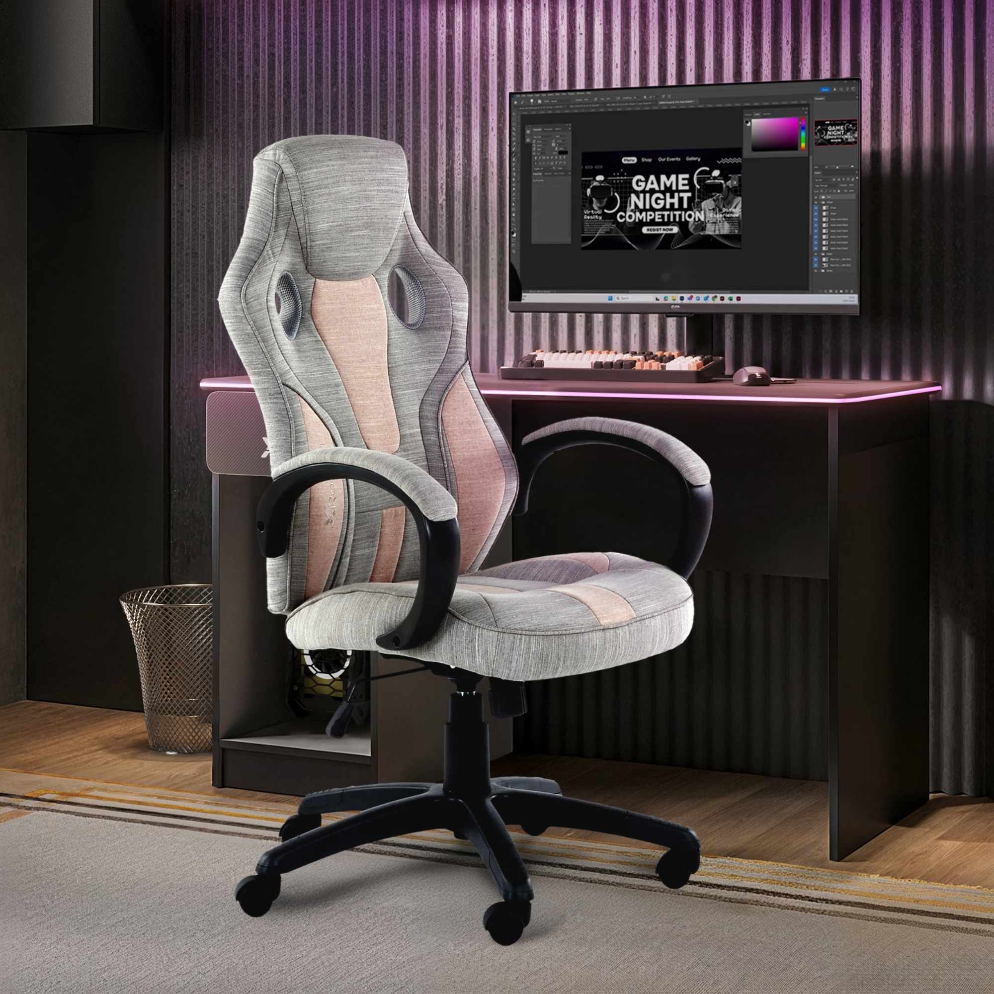Gray gaming chair in front of a computer desk with a monitor displaying a game night theme.