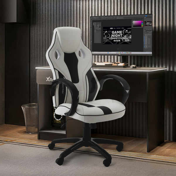 Gaming chair in front of a computer desk with a monitor displaying a game night theme.