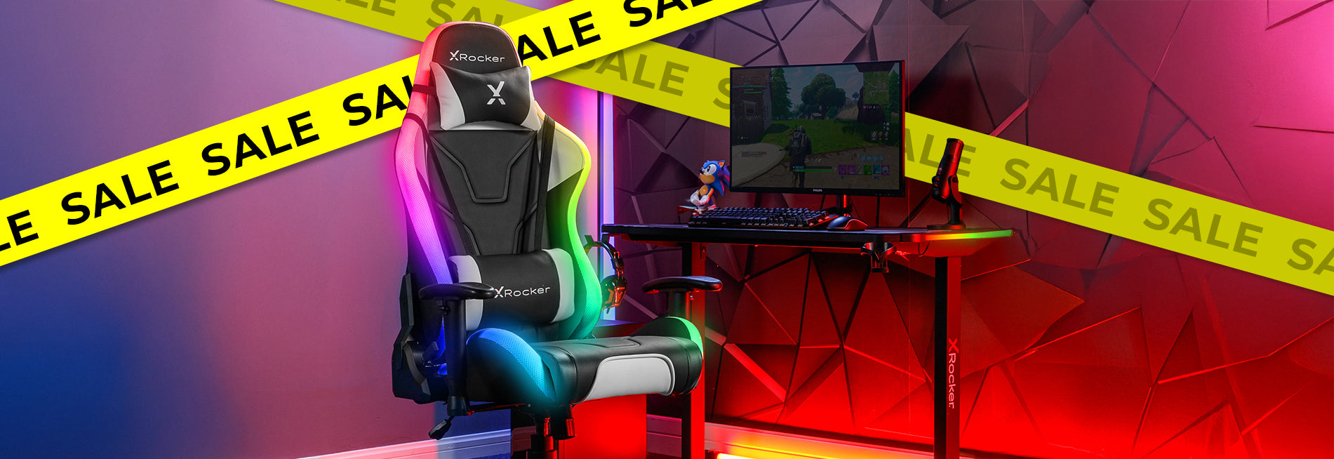 Gaming chair and desk setup with sale banners in the background
