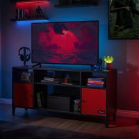 Modern entertainment console with a TV displaying a red and black scene, surrounded by gaming accessories.
