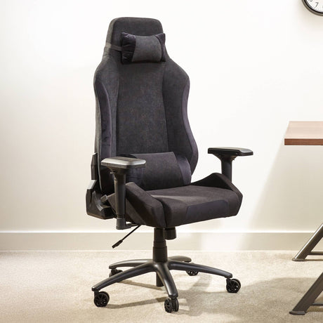 Black office chair in a room with a desk and clock.