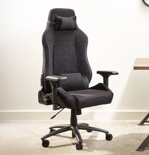 Black office chair in a room with a desk and clock.