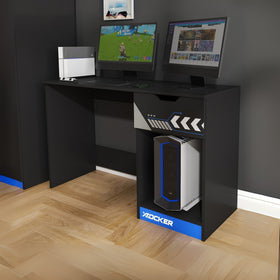 Black gaming desk with two monitors and a X rocker gaming chair on a wooden floor.