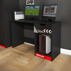 Gaming desk with computer setup and X rocker branding on a wooden floor.