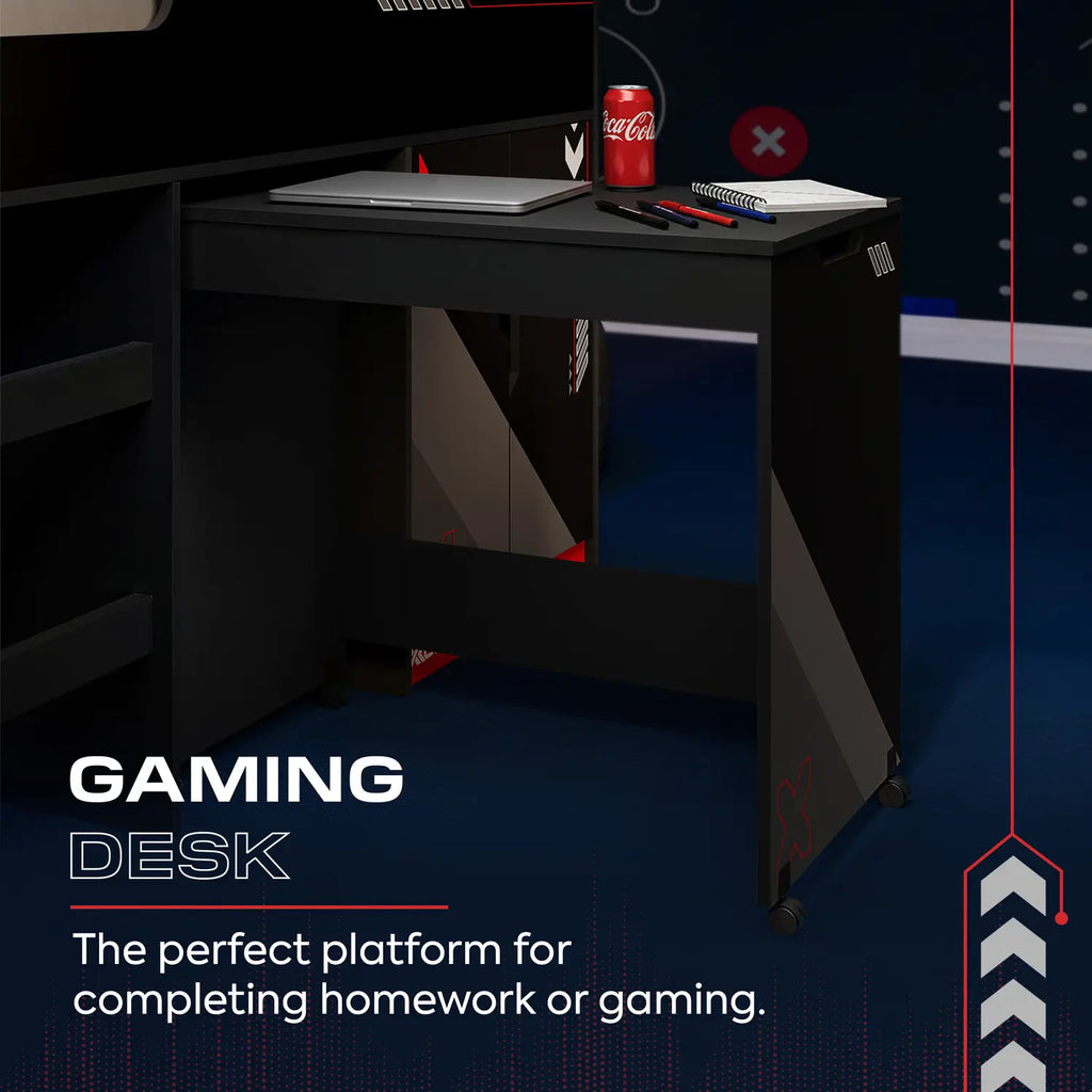 Gaming desk with a laptop, notebook, and Coca-Cola can on a dark background