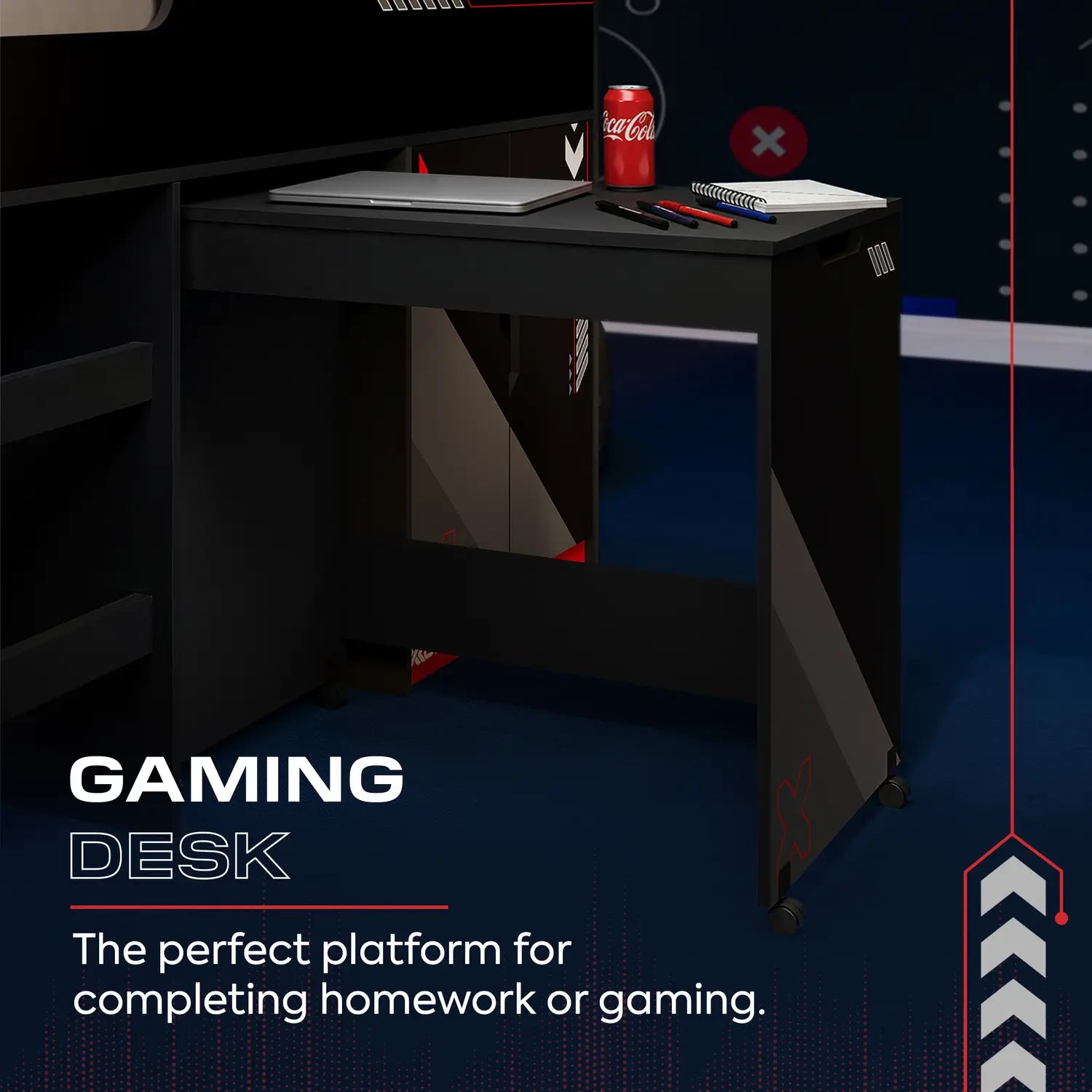Gaming desk with a laptop, notebook, and Coca-Cola can on a dark background