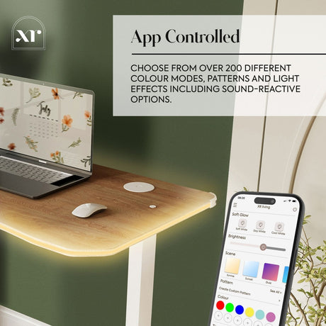 Laptop on a wooden desk with smartphone displaying app controls for color modes and light effects.