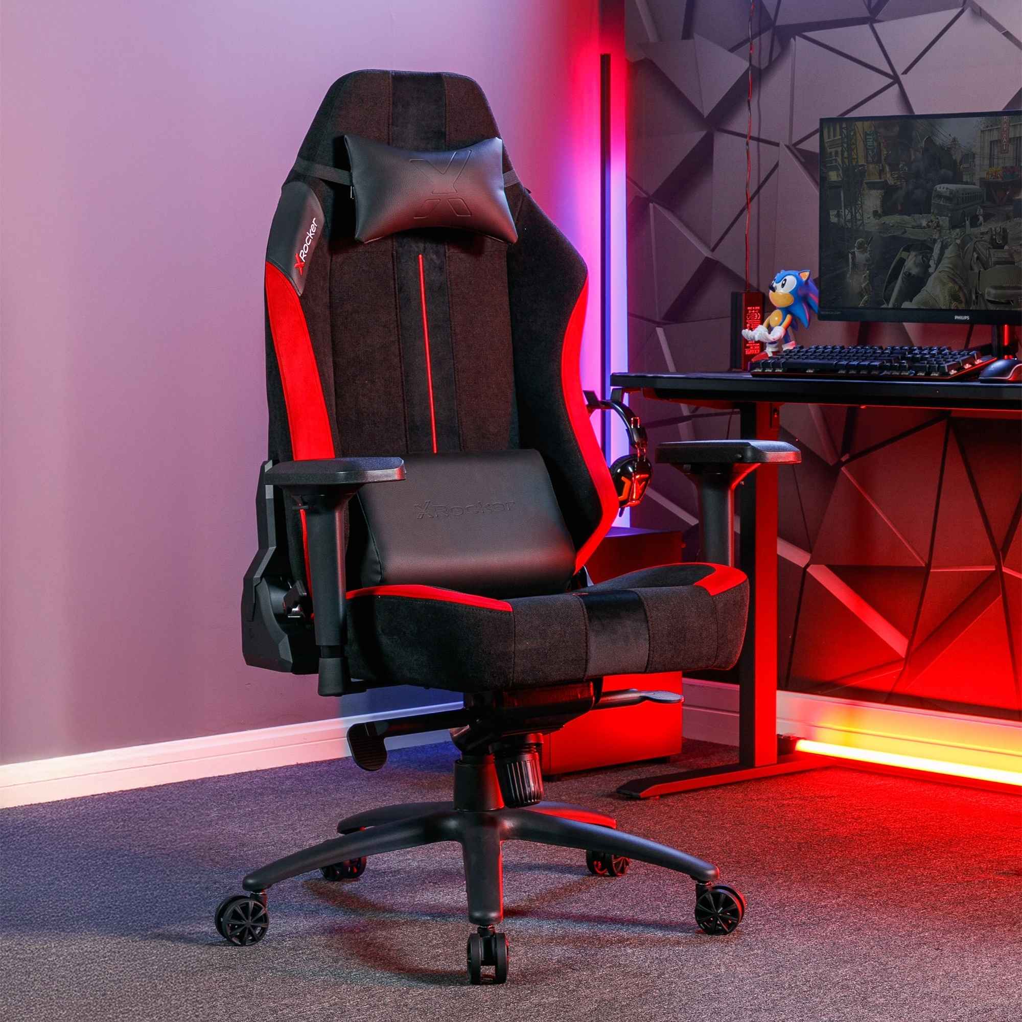 Gaming chair in a room with a desk and computer setup