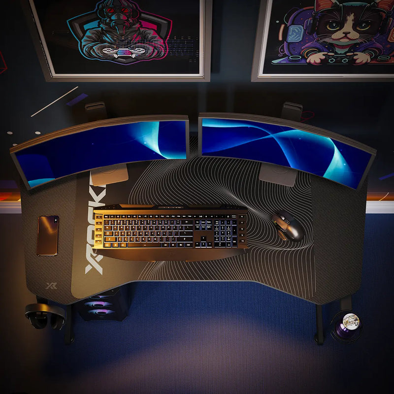 Panther Evo Gaming desk setup with dual monitors, keyboard, and mouse on a dark background