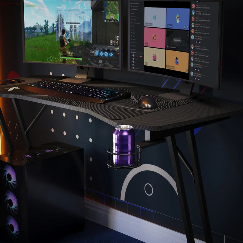 Gaming setup with multiple monitors on a panther evo desk in a dark room
