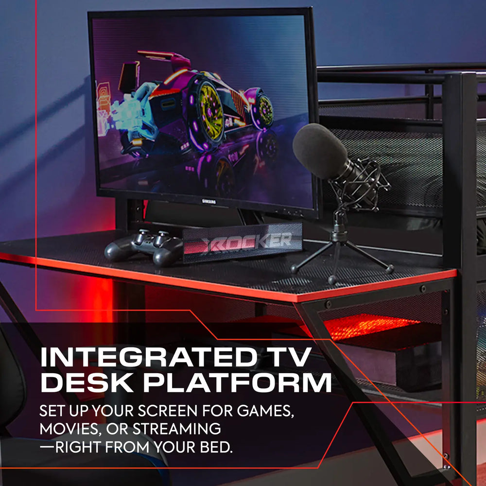 Gaming desk setup with monitor, microphone, and gaming controller on a dark surface.