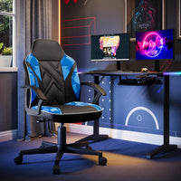 Gaming chair in a room with a desk and two monitors.