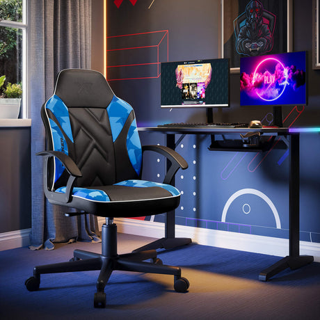 Gaming chair in a room with a desk and two monitors.