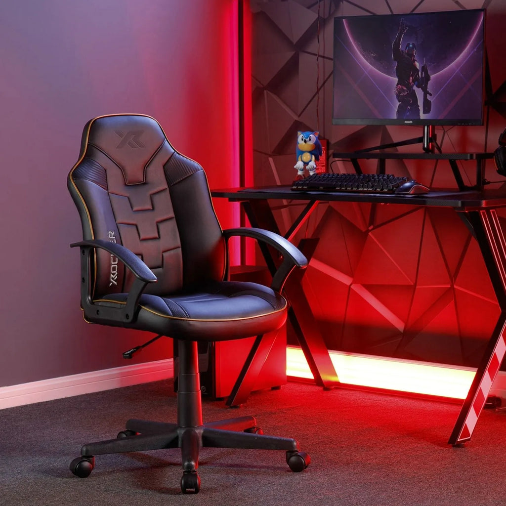 Gaming chair in a room with red lighting and a computer setup.