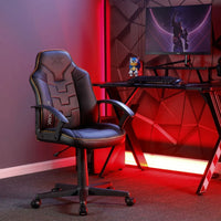 Gaming chair in a room with red lighting and a computer setup.