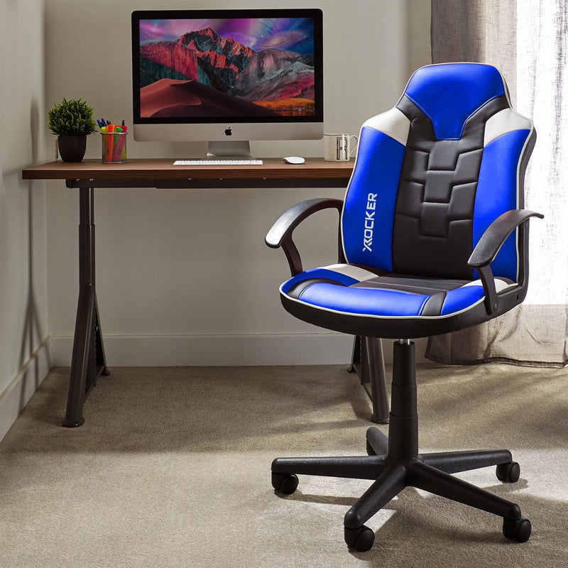 Blue and black office chair in front of a computer desk with a monitor displaying a mountain scene.