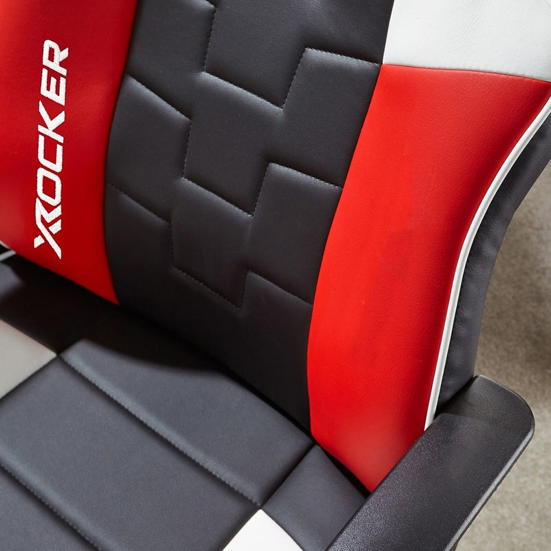 Close-up of a red and black gaming chair with 'X rocker' branding.