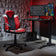 Gaming setup with red and black chair, desk, and dual monitors in a room with geometric wall design.