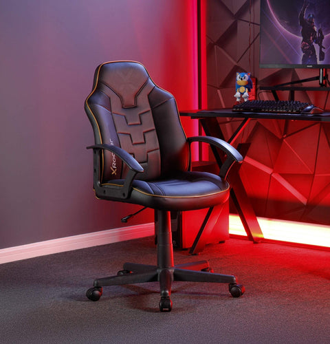 Gaming chair in a room with red lighting and a computer setup.