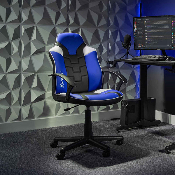 Gaming chair with blue and black design in a room with a geometric wall pattern.