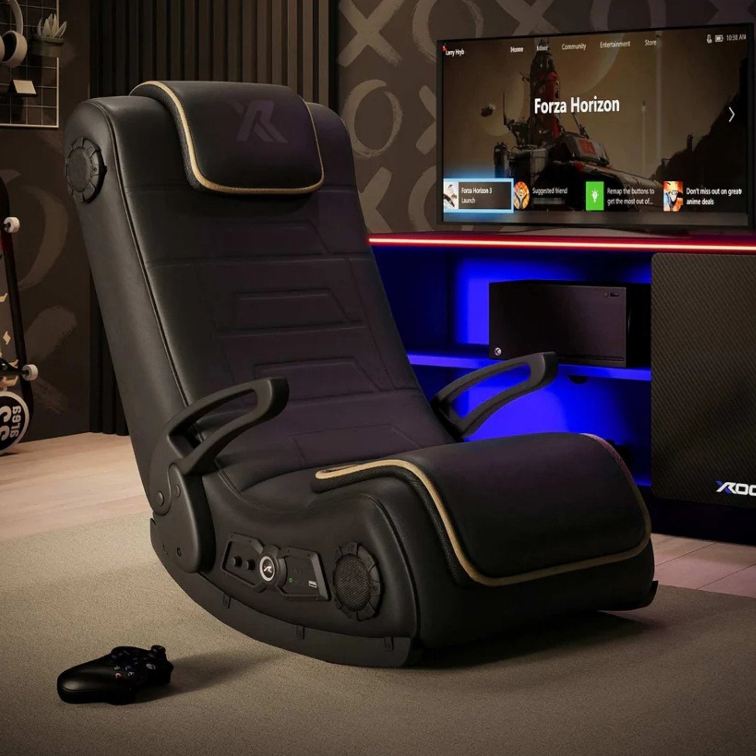 Black gaming chair with control panel in a room with a TV displaying 'Forza Horizon'.