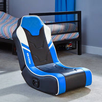 Blue and black gaming chair in a room with a bed and shelves.
