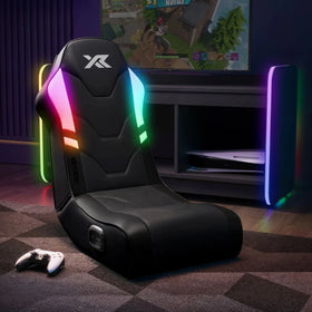 Gaming chair with RGB lighting in a room setup with a TV and gaming console.