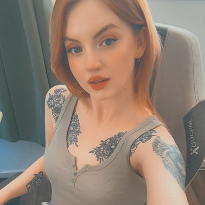 Woman with tattoos sitting in a gaming chair