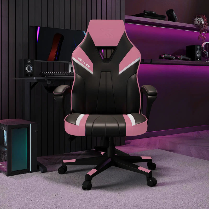 Gaming chair with pink accents in a room setup with computer equipment.
