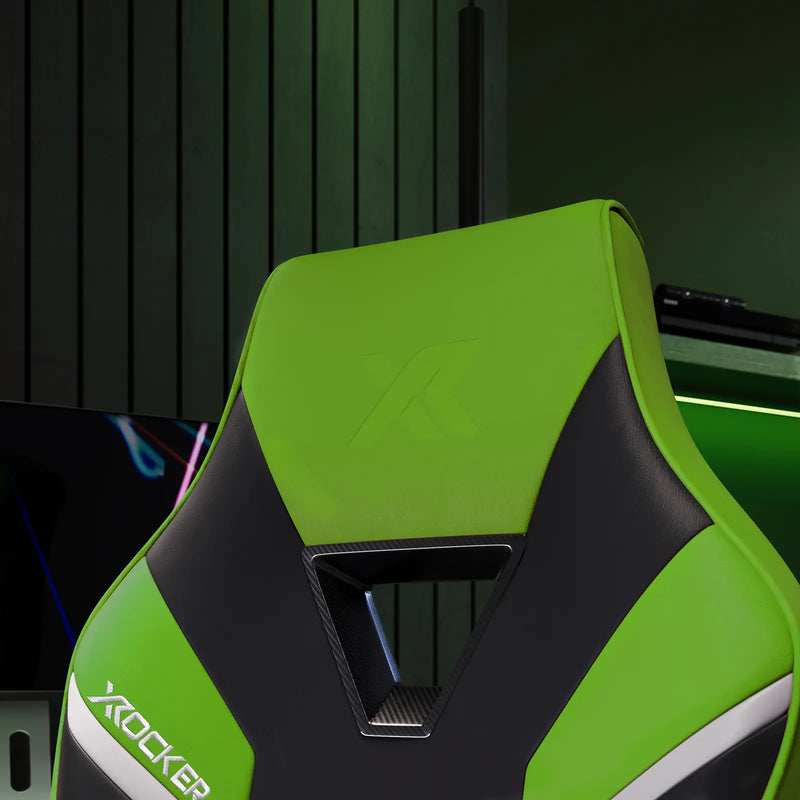 Green and black X rocker gaming chair with a blurred background