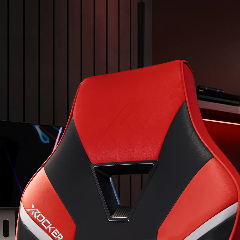 Red and black gaming chair with X rocker logo on a blurred background