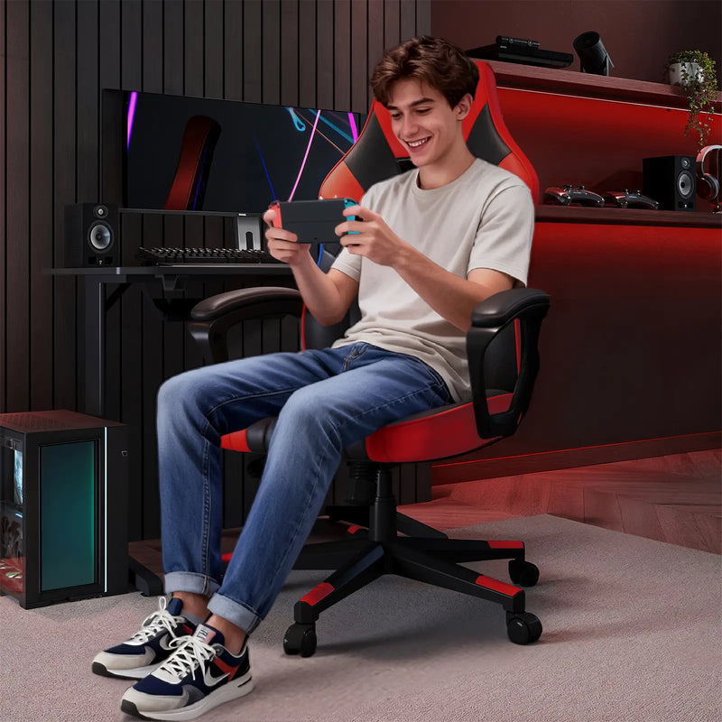 Person sitting in a gaming chair using a smartphone in a room with gaming equipment.