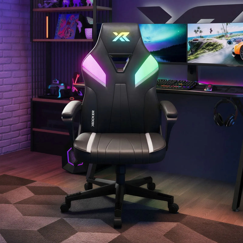 Gaming chair with RGB lighting in a gaming setup with multiple monitors and accessories.