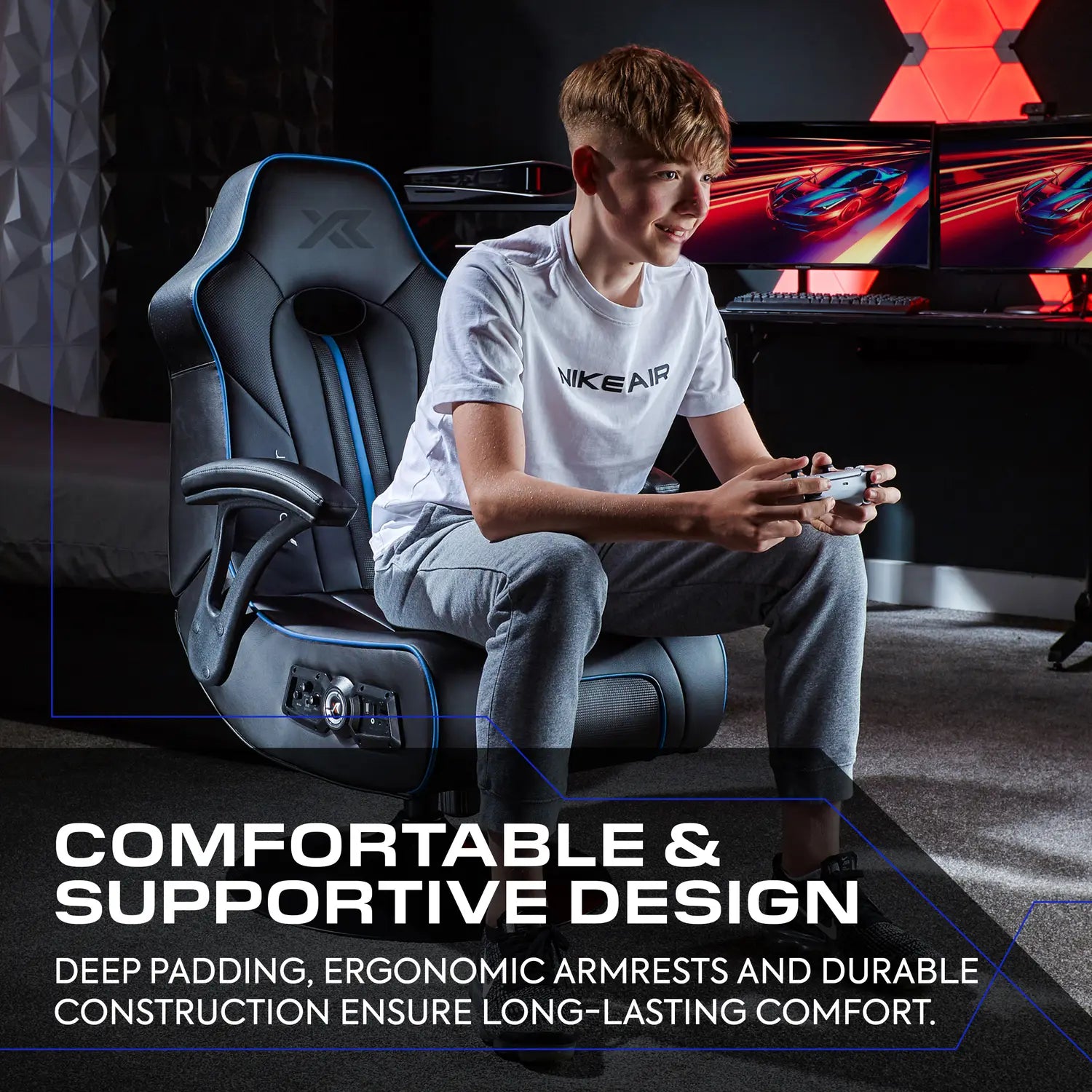 Person sitting on a gaming chair in a room with gaming setup, text about chair comfort and support.