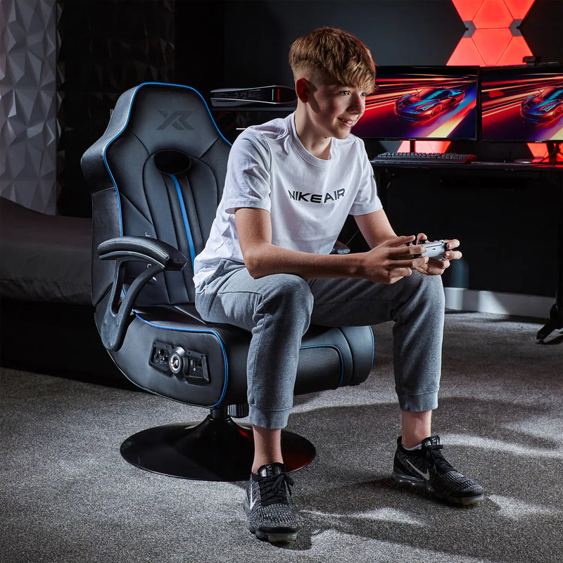 Person sitting in a Torque console gaming chair in a room with gaming setup