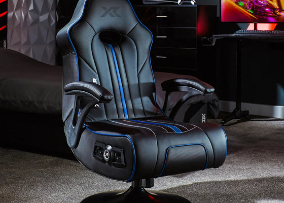 Gaming chair with blue accents in a room with a computer setup.