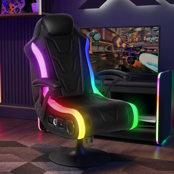 Gaming chair with RGB lighting in a room with a gaming setup.