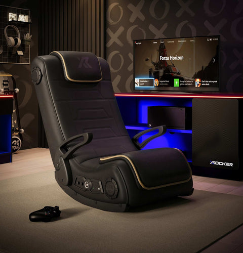Gaming chair in a room with a TV displaying a game, surrounded by gaming accessories.