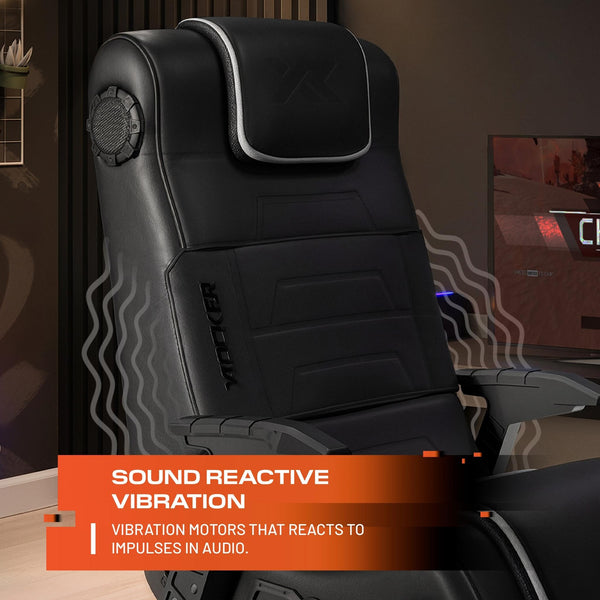 Black gaming chair with vibration motors labeled 'Sound Reactive Vibration' in a room setting.