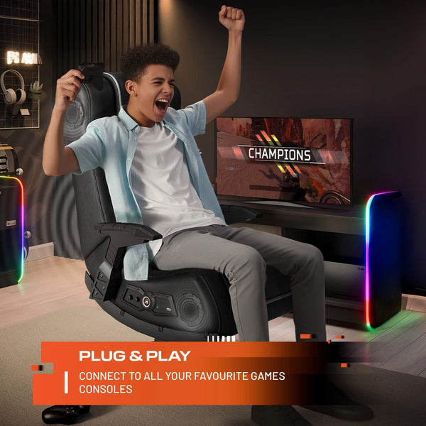 Person playing video games in a gaming chair with a TV screen displaying 'Champions'.