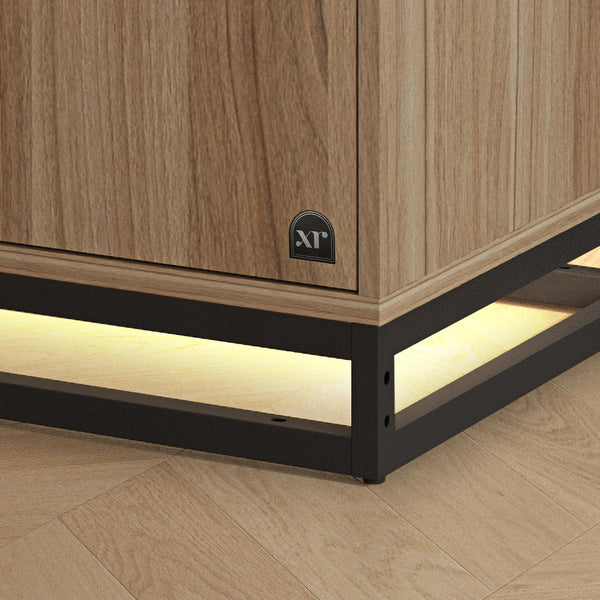 Wooden cabinet with black frame and LED lighting on a wooden floor