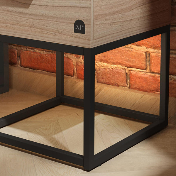 Wooden side table with black metal frame against a brick wall.