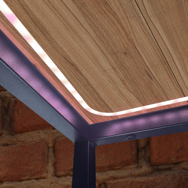 Wooden table with purple metal frame against a brick wall