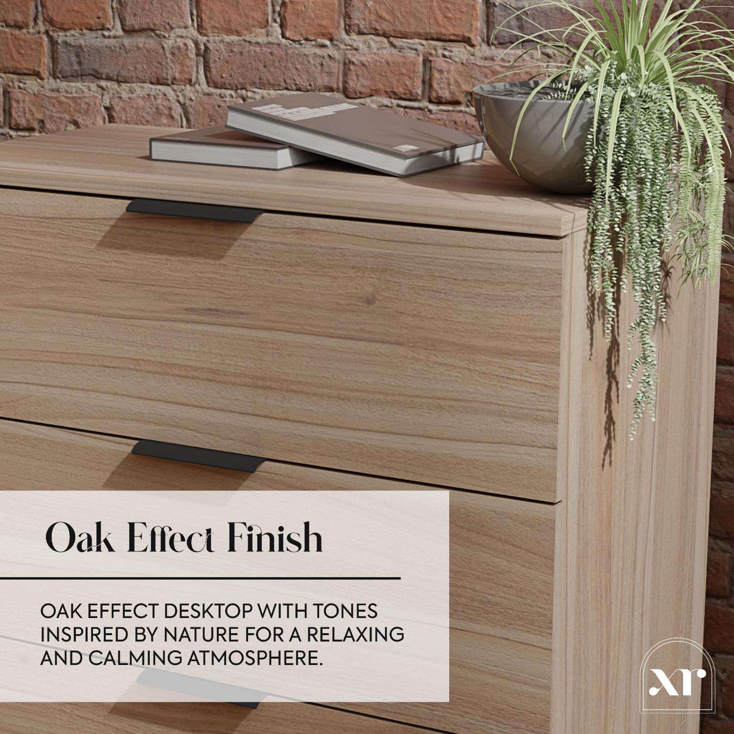 Wooden desk with books and a plant against a brick wall, featuring an oak effect finish.