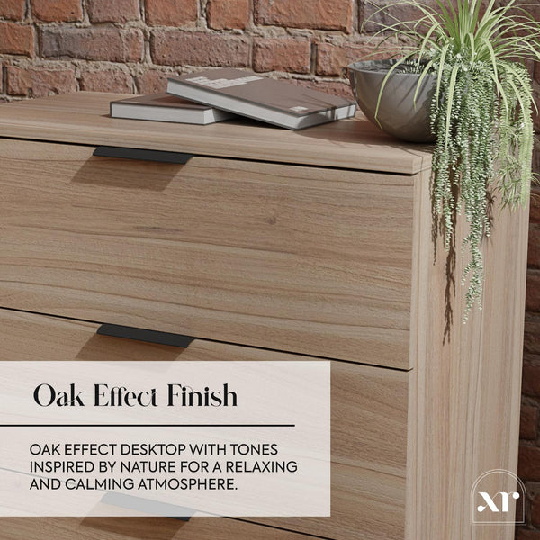 Wooden desk with books and a plant against a brick wall, featuring an oak effect finish.