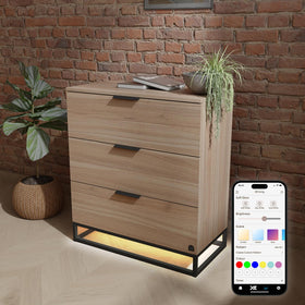 Wooden dresser with LED lighting and smartphone app control against a brick wall.